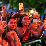 Festivalgoers at Curaçao North Sea Jazz Festival watching and recording a live performance